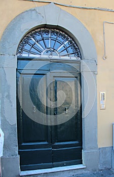 The door is beautifully framed by a stone portal with an arch