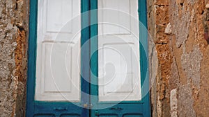 Door blue painted in rustic house in Sicily city Marzamemi