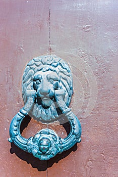 Door with brass knocker in the shape of a lion`s head, beautiful