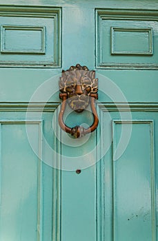 Door with brass knocker in the shape of a lion`s head, beautiful