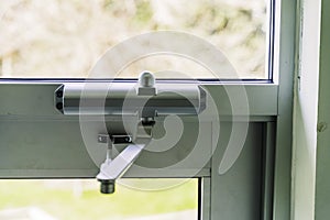 Door Closer on Glass door on building entrace photo