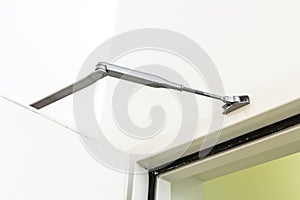 Door closer or shock absorber installation, automatic closing photo