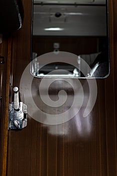 Door and doorknob in a train compartment. Travel by train.
