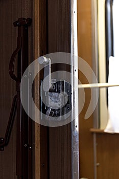 Door and doorknob in a train compartment. Travel by train.