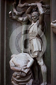 Door of the duome, Milan, executioner executes human. Bronze bas-relief