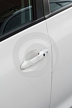 Door handle close-up of a white modern car