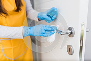 Door handle disinfection with wet wipe and antiseptic sprayer