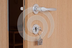 Door handle with inserted key with house icon keyring