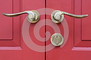 Door handles on red wood door