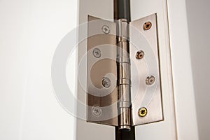 Door hinges Aluminum on white door close up
