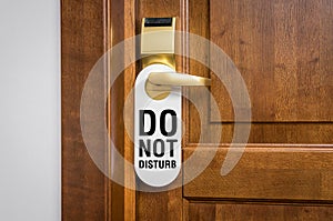 Door of hotel room with sign please do not disturb