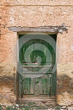 Door of a house in Zaragoza, Spain, with visible deterioration.
