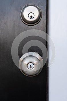 Door knob and Deadbolt on a black door.