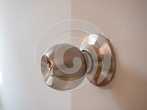 Door knob,On wood white door,Material Stainless,Beautiful lighting,Sunlight,Security lock,Closeup detail