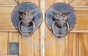 Door knocker on the door of traditional Chinese building.