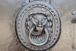 Door knocker on old wood and messing door