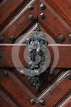 door knocker on an old wooden door in Prague