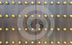 The door and knockers of Chinese temple. Ancient Asian door from temple. Chinese door. Oriental design of door of palace hall in F