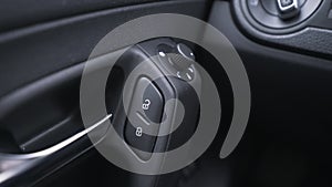 Door lock buttons inside a car. Action. Close up of car interior details with a vehicle door, concept of transport