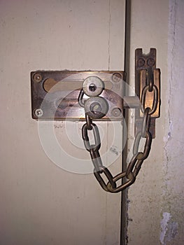 The door lock on the latch uses a chain