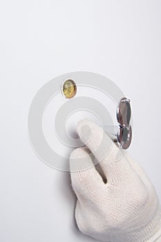 A door and mechanism installer, wearing protective gloves, sets up a peephole for observation