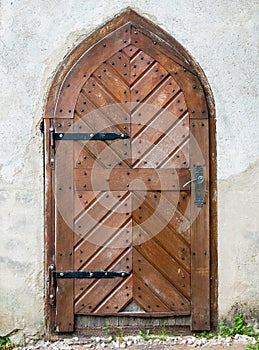 Door from a medieval old buliding. Closed wooden door