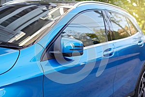 Door mirror of new blue car