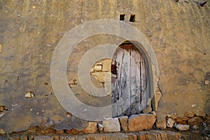 door of an old house built of cement and stones