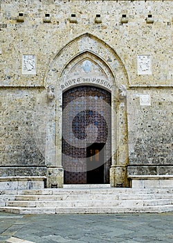 Door of Palazzo Spannocchi in Piazza Salimbeni. Siena, Italy