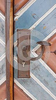 Door panel with handle and brown and blue painted boards