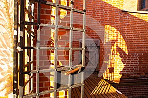 A door and part of brick wall with shadows inside a castle