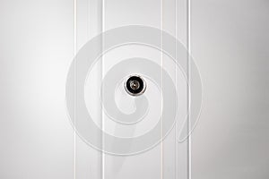 Door Peephole on a white wooden door