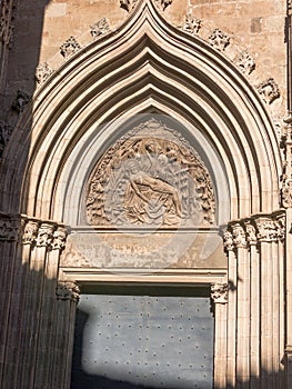 The Door of piety. Cathedral Of The Holy Cross And Saint Eulalia In Barcelona, Spain