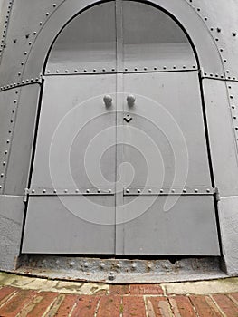 door riveted steel brick wall of the water