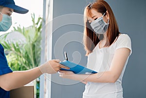 Door to door delivery express sending send a package wearing mask to customer receiver sign