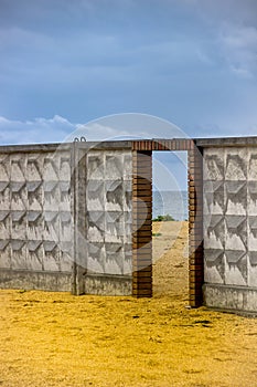 A door to the sea on concrete fence on the sea beach