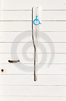 Door of toilets with an oar decorated with symbols