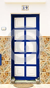 Door with white squares framed in blue in a building in La Graciosa photo