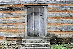 Door in wood and brick log cabin