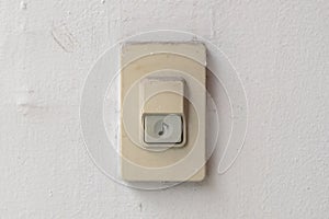 Doorbell or buzzer on gray wall