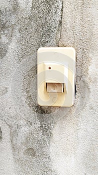 doorbell or buzzer on gray wall