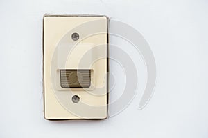 Doorbell or buzzer on white concrete wall