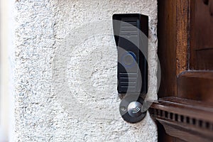 Doorbell with remote door opening near the vintage door, in the old part of town