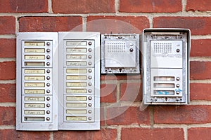 Doorbells or intercoms outside a block of flats or apartments with the flat numbers written next to the buttons