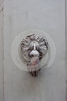 Doorknocker on the front door of the Italian building