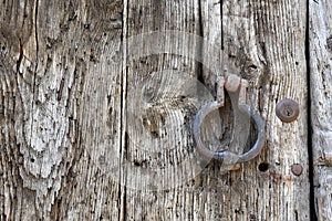 Doorknocker on a weathered wooden door