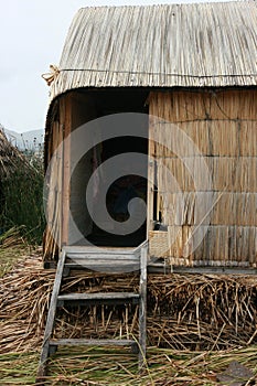 Dooropening of a hut made of reeds by the native indians that is standing in a man made island at Lake Titicaca in Peru, South