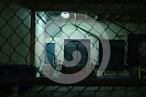 Doors through the metal fence at night