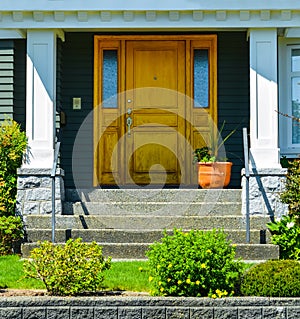 Doorsteps to the entrance of family house with landscaped front yard