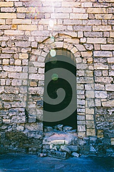 The doorway in the fortress to the ruins of an ancient city in the sunlight.